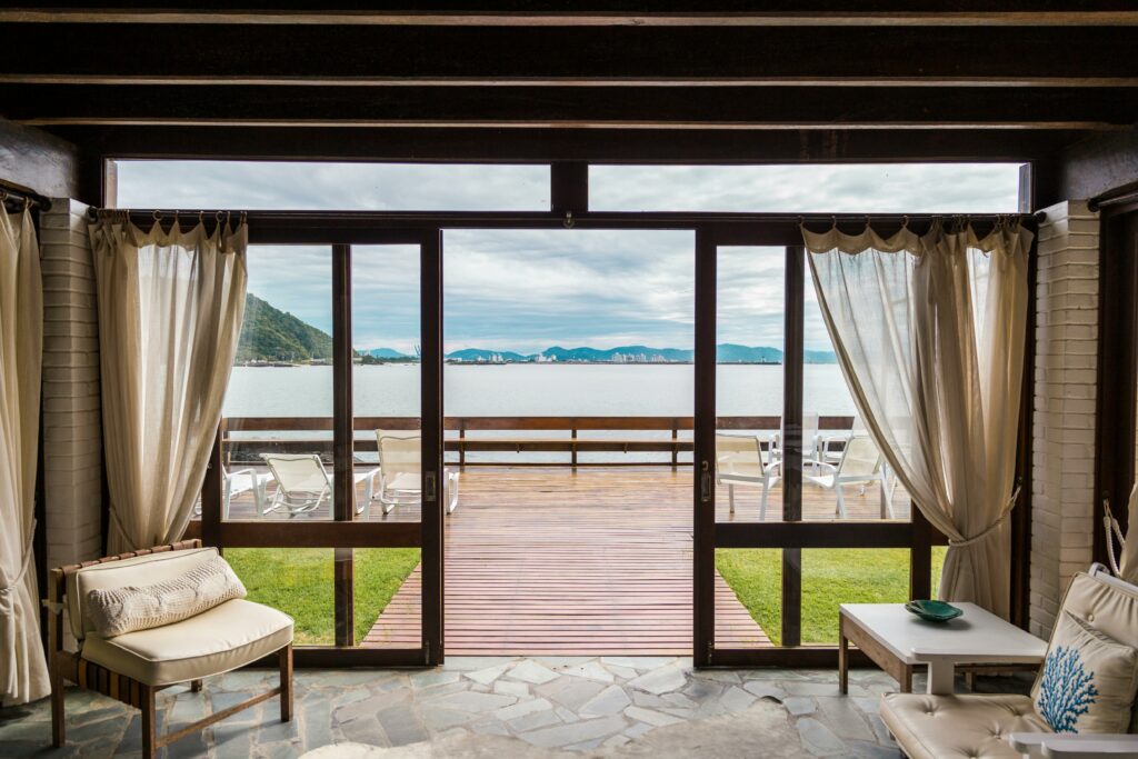 Elegant room with ocean view from large windows overlooking the beach in Brasil.